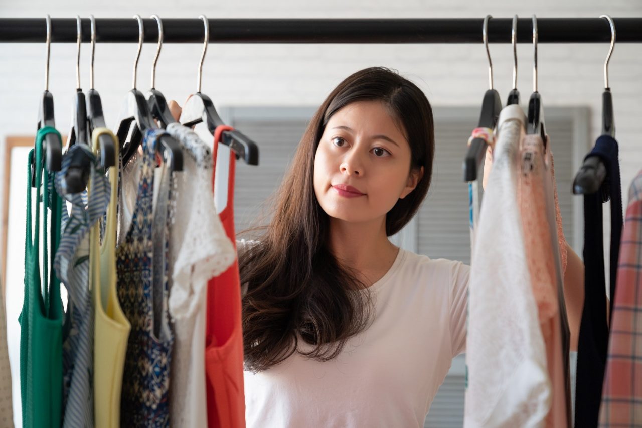 Woman Choosing Clothes for Summer Funeral